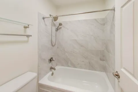 a bathroom with a shower and a bath tub