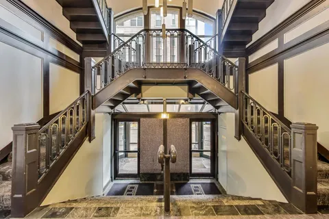 a view of hallway with stairs and furniture