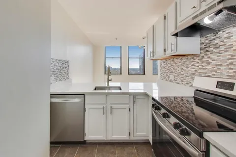 a kitchen with a sink appliances and cabinets