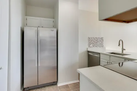 a kitchen with stainless steel appliances a refrigerator and sink