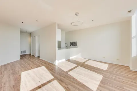 a view of a room with wooden floor and white walls