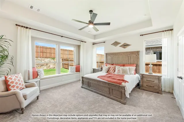 a bedroom with a bed a dresser and a large window