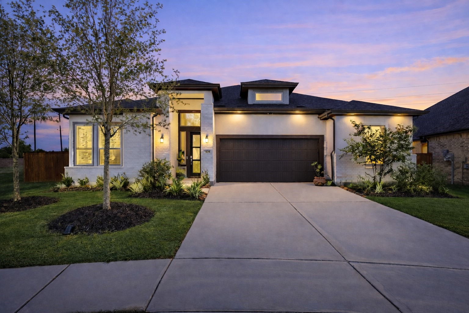 Welcome home to 7403 Hanover Ln! This modern 1 story home greets you with a modern exterior, sensational curb appeal, lush landscaping, white brick with contrasting dark trim, and oversized 3 car wide garage!
