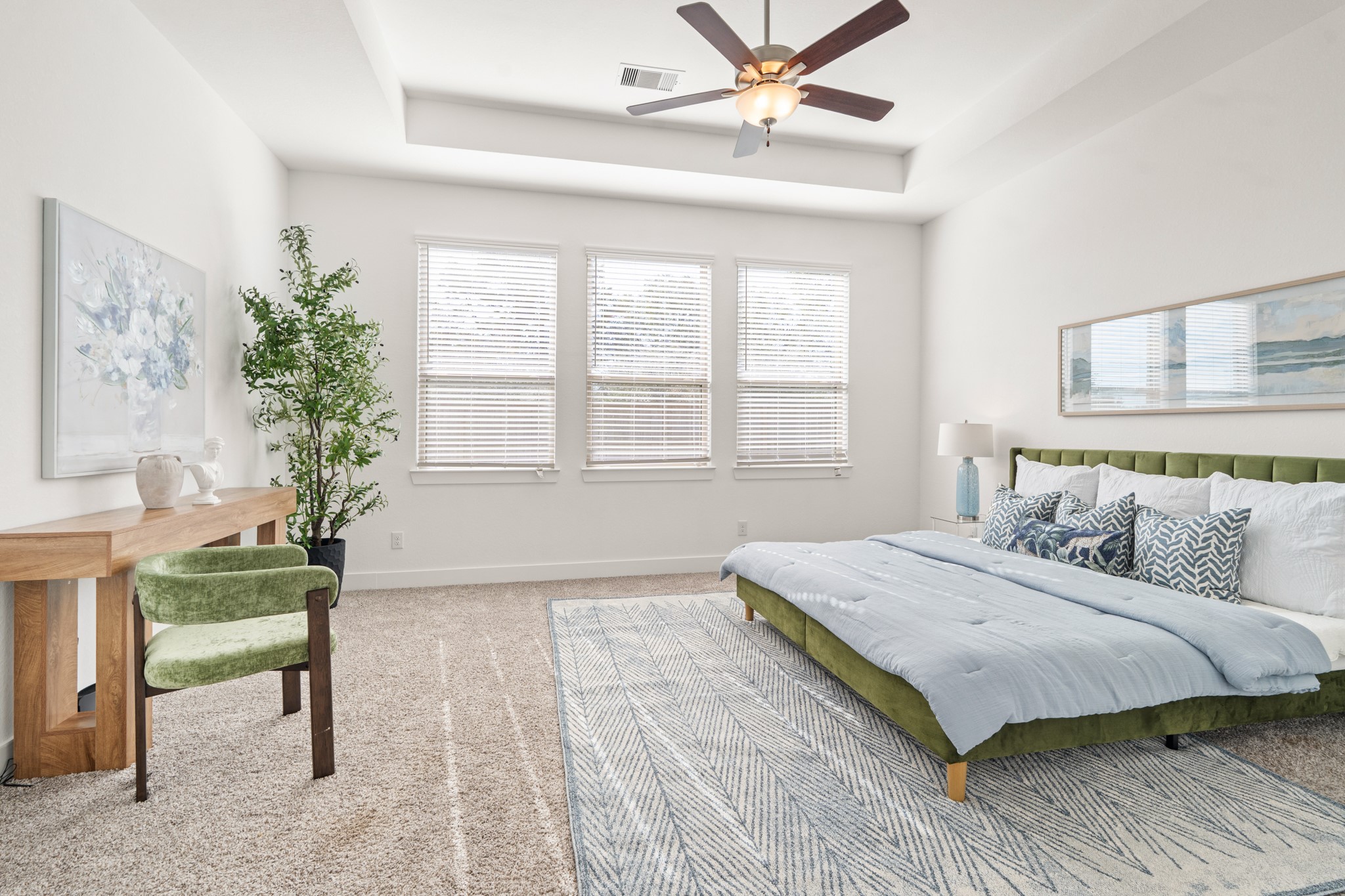 7403 Hanover Lane Katy, TX 77493 - Photo 18 of 46 The primary bedroom welcomes you with bright natural light, high tray ceilings, a ceiling fan, and the perfect view of the serene yard. It sits at the back of the home offering additional privacy and easily fits a king size bed plus furniture!