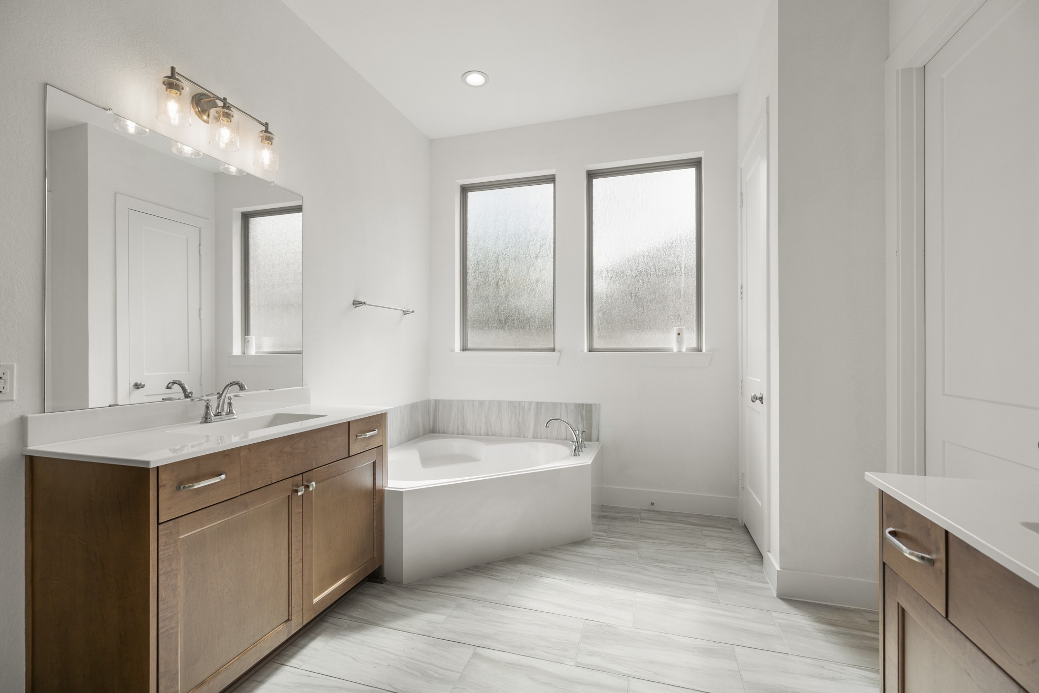 7403 Hanover Lane Katy, TX 77493 - Photo 22 of 46 A spa sized garden tub with tile surround sits separately and is tucked into a nook, allowing for a tranquil retreat!