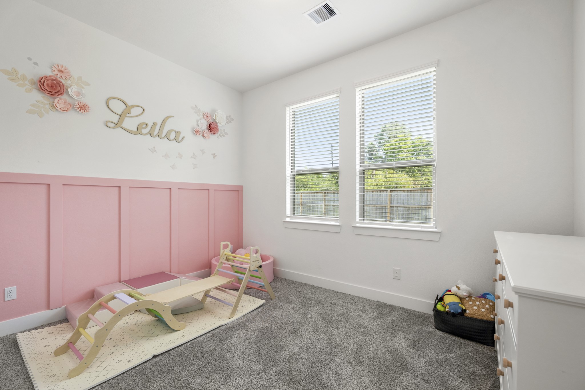 7403 Hanover Lane Katy, TX 77493 - Photo 28 of 46 Bright, airy, and effortlessly inviting! This secondary bedroom features warm plush carpet, an accent wall, bright natural light, and a private vanity area connecting to the jack and jill bathroom!