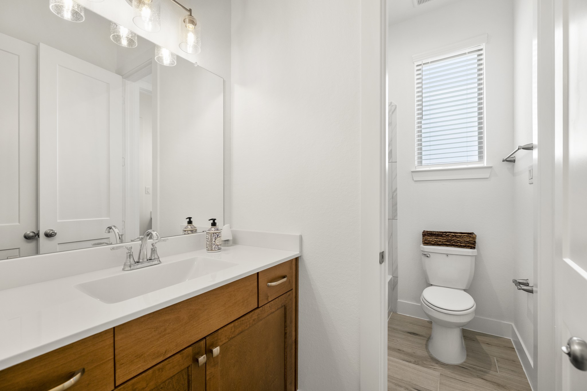7403 Hanover Lane Katy, TX 77493 - Photo 29 of 46 A jack and jill bathroom is the perfect set up for sharing! This private vanity area features an oversized vanity with quartz countertops, a large mirror, and plenty of storage.