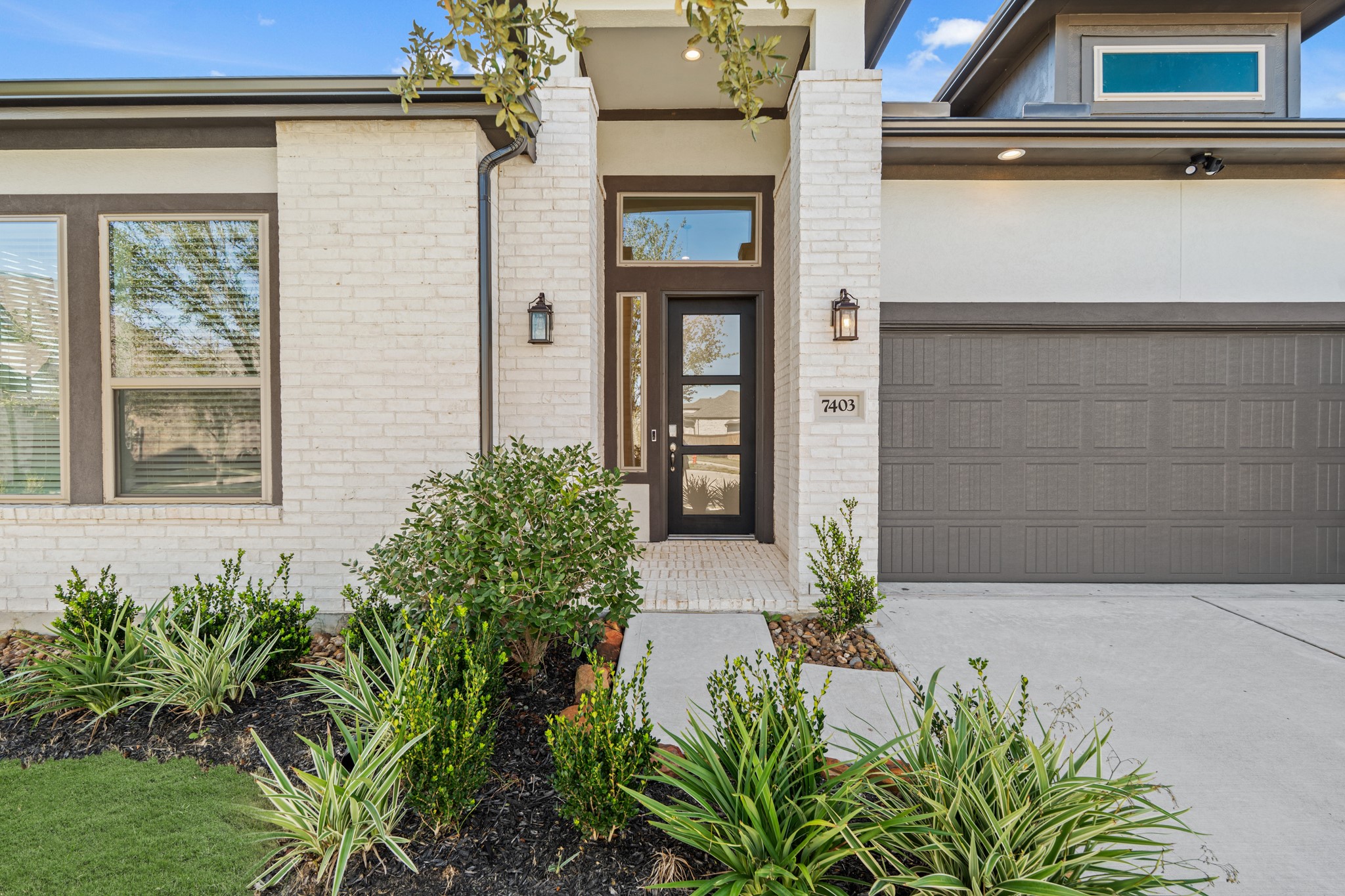 7403 Hanover Lane Katy, TX 77493 - Photo 3 of 46 As you approach the home, you're greeted by a stunning first impression, featuring a spacious brick paved porch, 8ft. Mahogany modern door, keyless entry, and a smart door bell!
