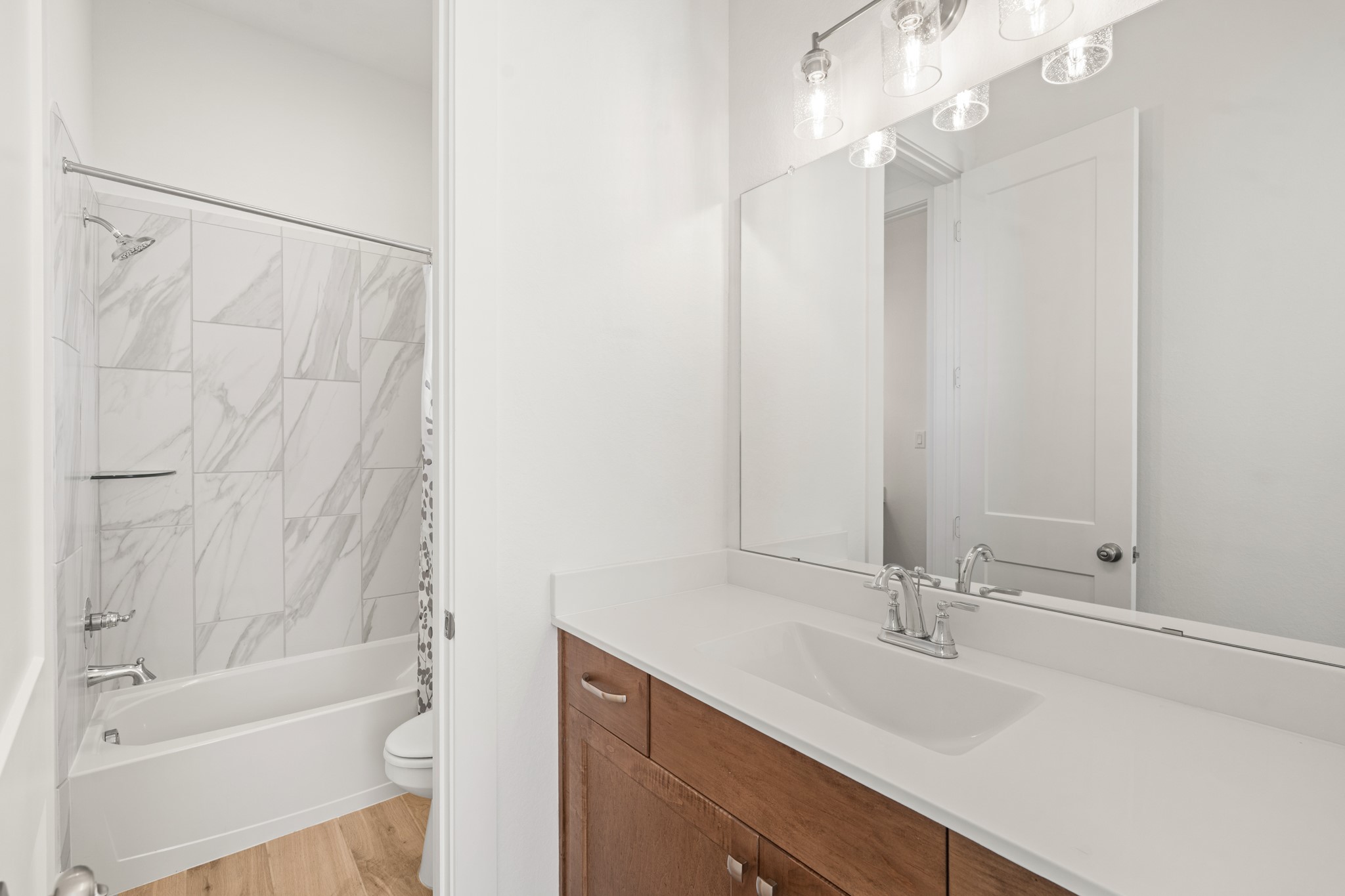 7403 Hanover Lane Katy, TX 77493 - Photo 31 of 46 A jack and jill bathroom is the perfect set up for sharing! This private vanity area features an oversized vanity with quartz countertops, a large mirror, and plenty of storage.