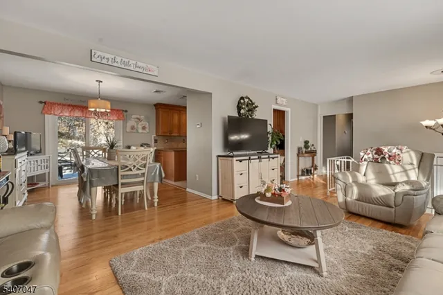 a living room with furniture and view of kitchen