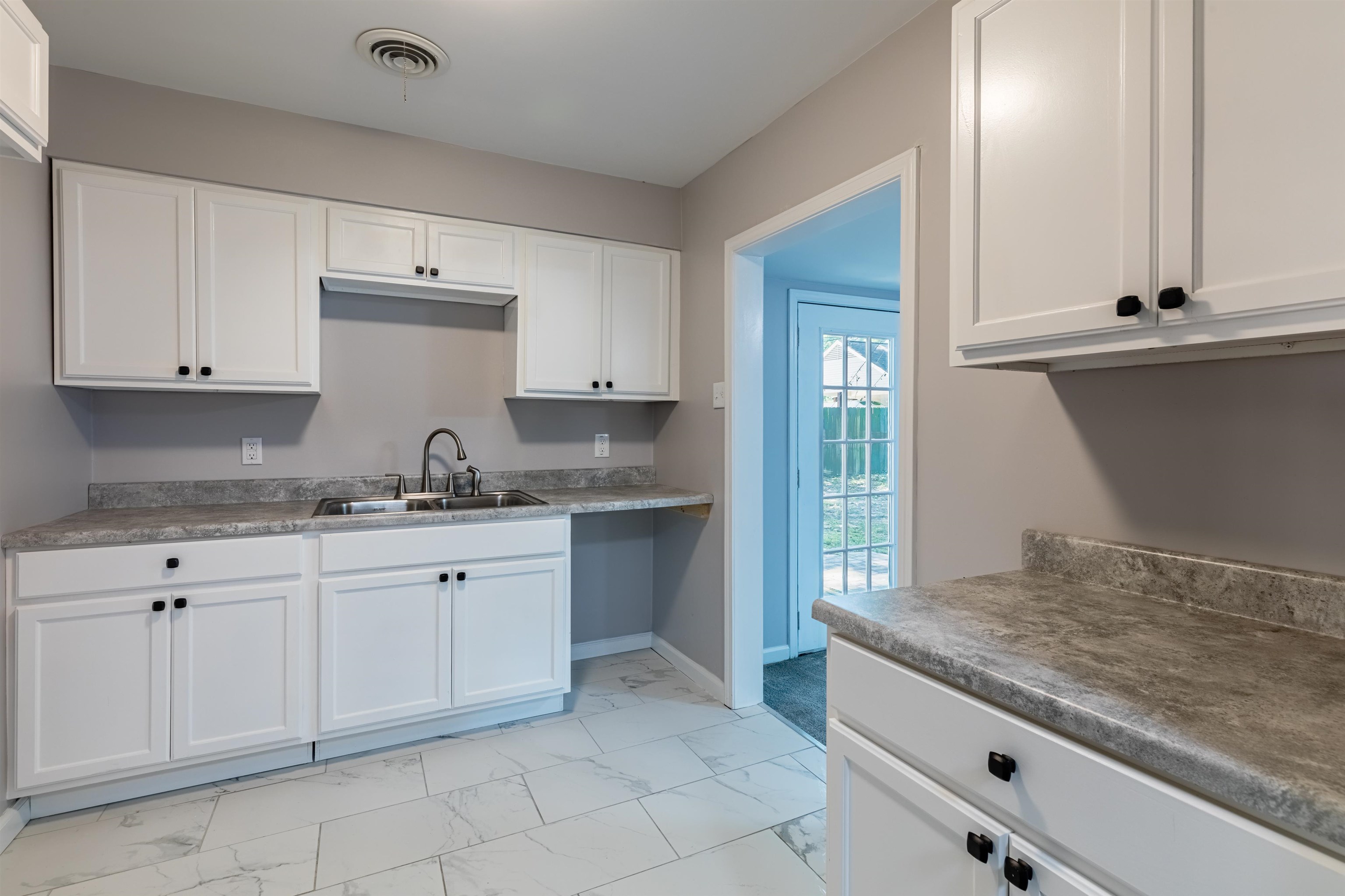 4400 Helene Road Memphis, TN 38117 - Photo 12 of 31 a kitchen with granite countertop white cabinets and white appliances