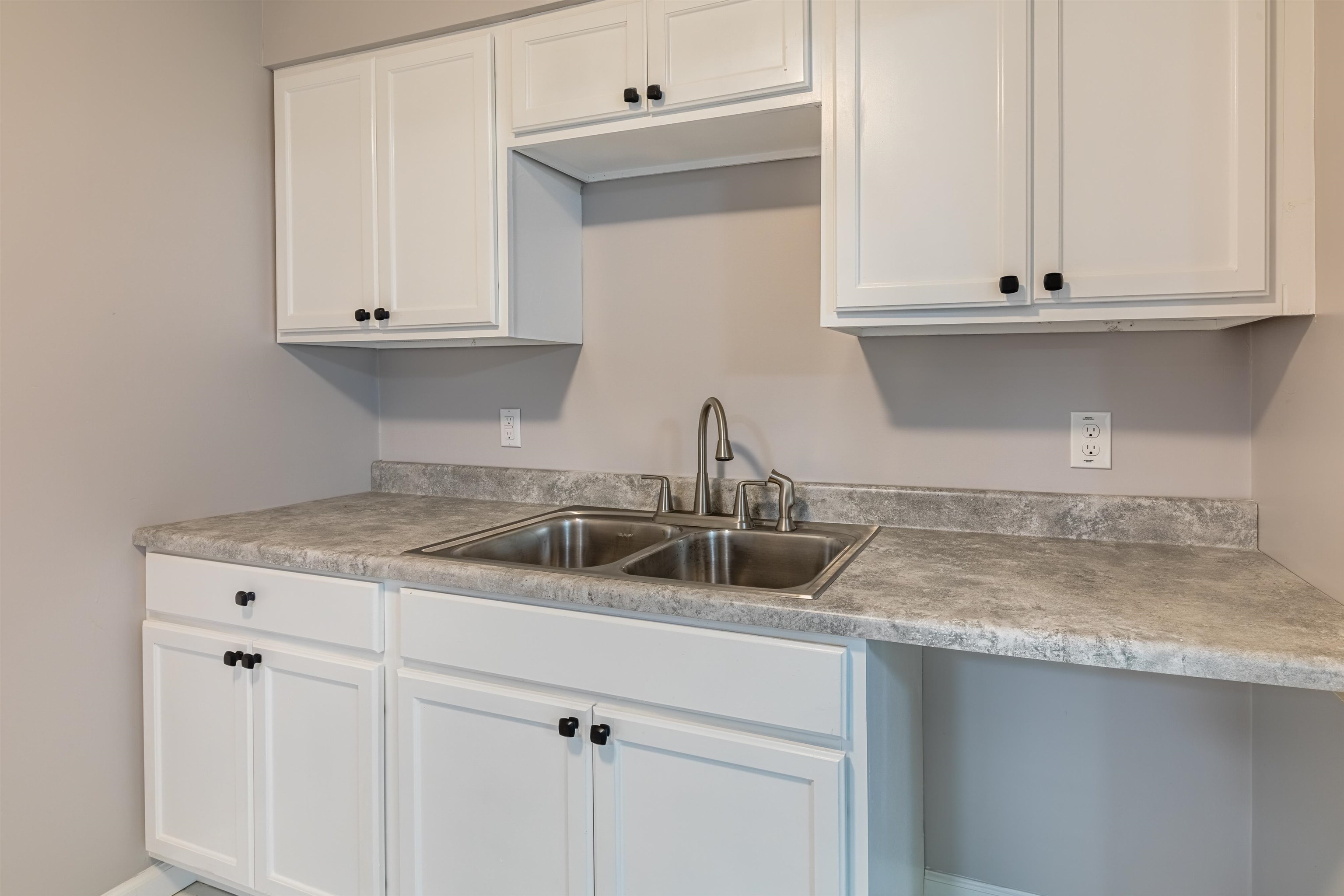 4400 Helene Road Memphis, TN 38117 - Photo 14 of 31 a kitchen with granite countertop white cabinets and a sink