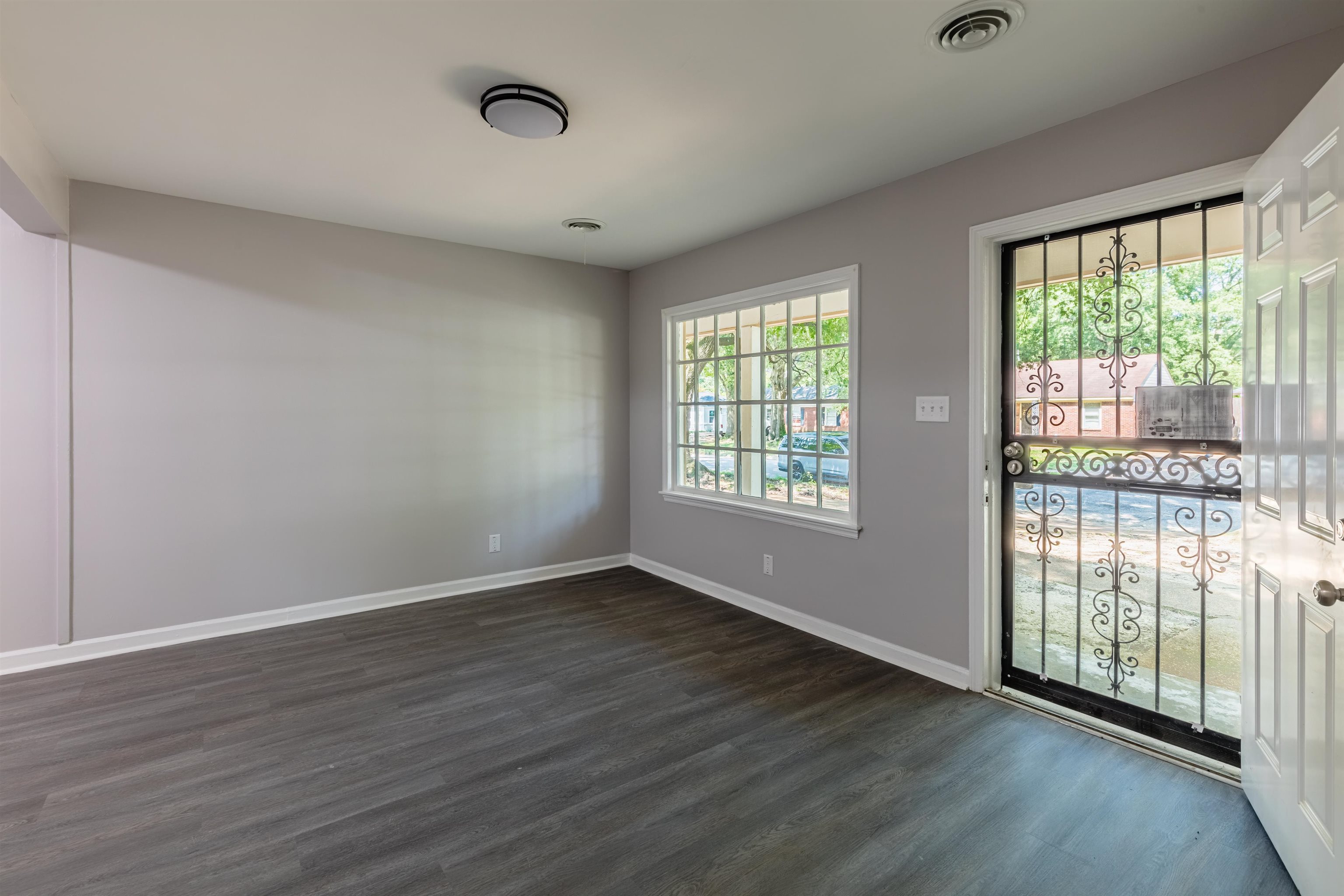4400 Helene Road Memphis, TN 38117 - Photo 9 of 31 a view of an empty room with wooden floor and a window