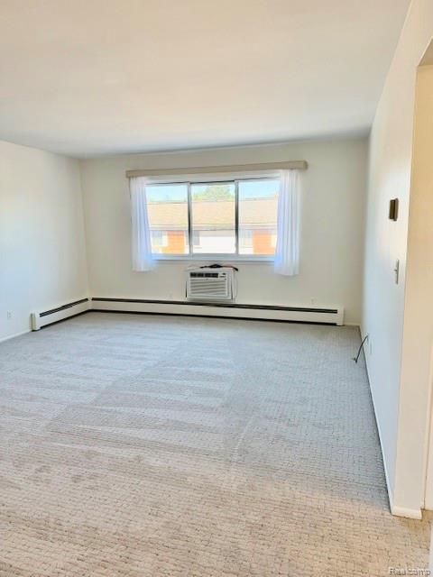 805 Plate Street, Unit 210 Rochester, MI 48307 - Photo 10 of 20 Spare room with light colored carpet and a baseboard radiator