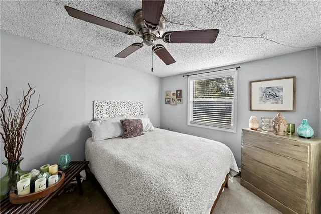 a bedroom with a bed and ceiling fan