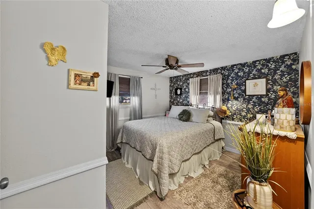 a spacious bedroom with a bed and a table in it