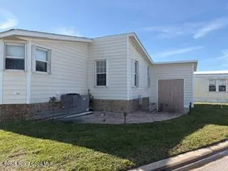 a view of house with backyard