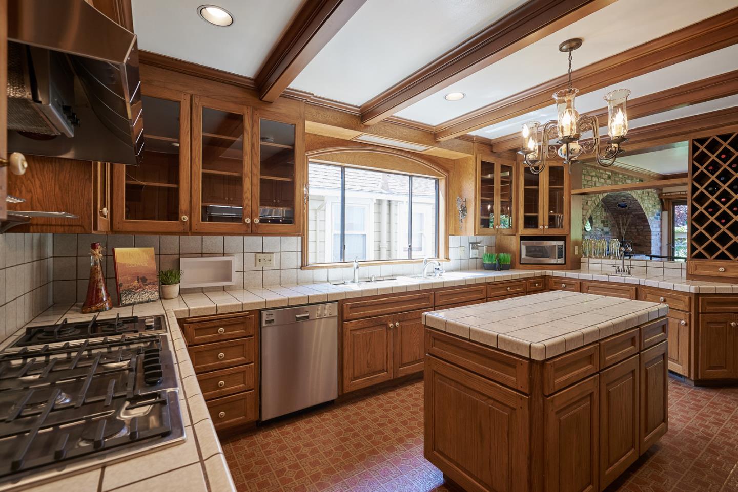 17 Bancroft Road Burlingame, CA 94010 - Photo 8 of 25 a kitchen with stainless steel appliances granite countertop a stove a sink and a microwave