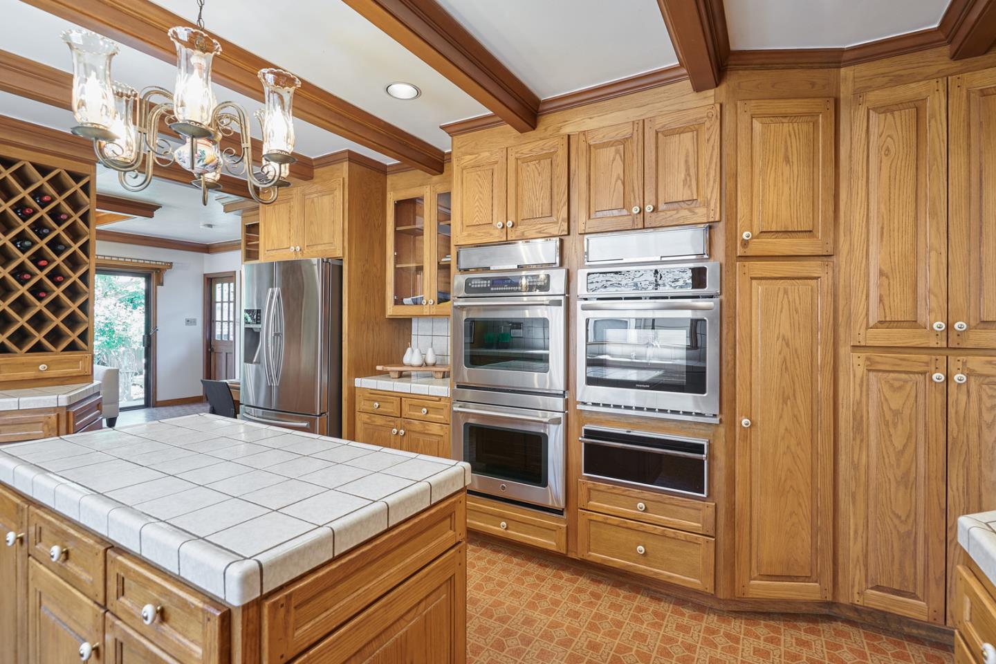 17 Bancroft Road Burlingame, CA 94010 - Photo 9 of 25 a kitchen with stainless steel appliances kitchen island granite countertop a refrigerator and a stove top oven