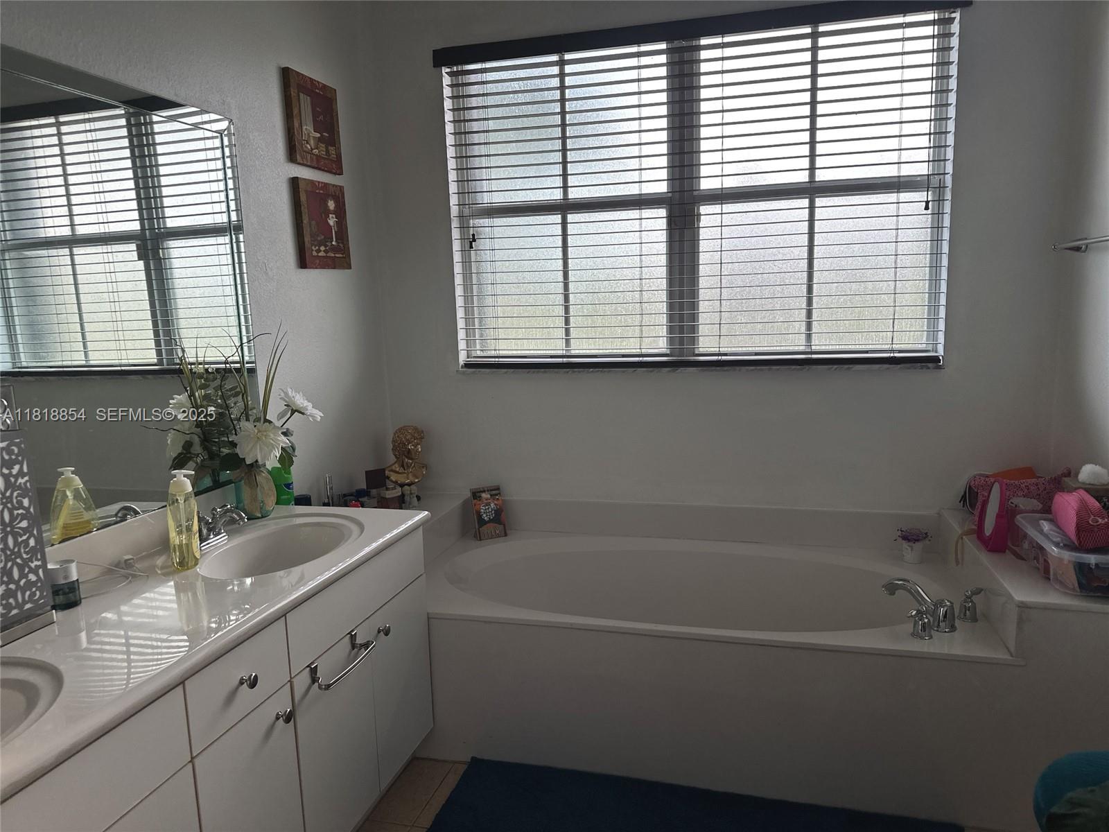 16419 Southwest 84th Street Miami, FL 33193 - Photo 11 of 15 a bathroom with a tub a sink and a window