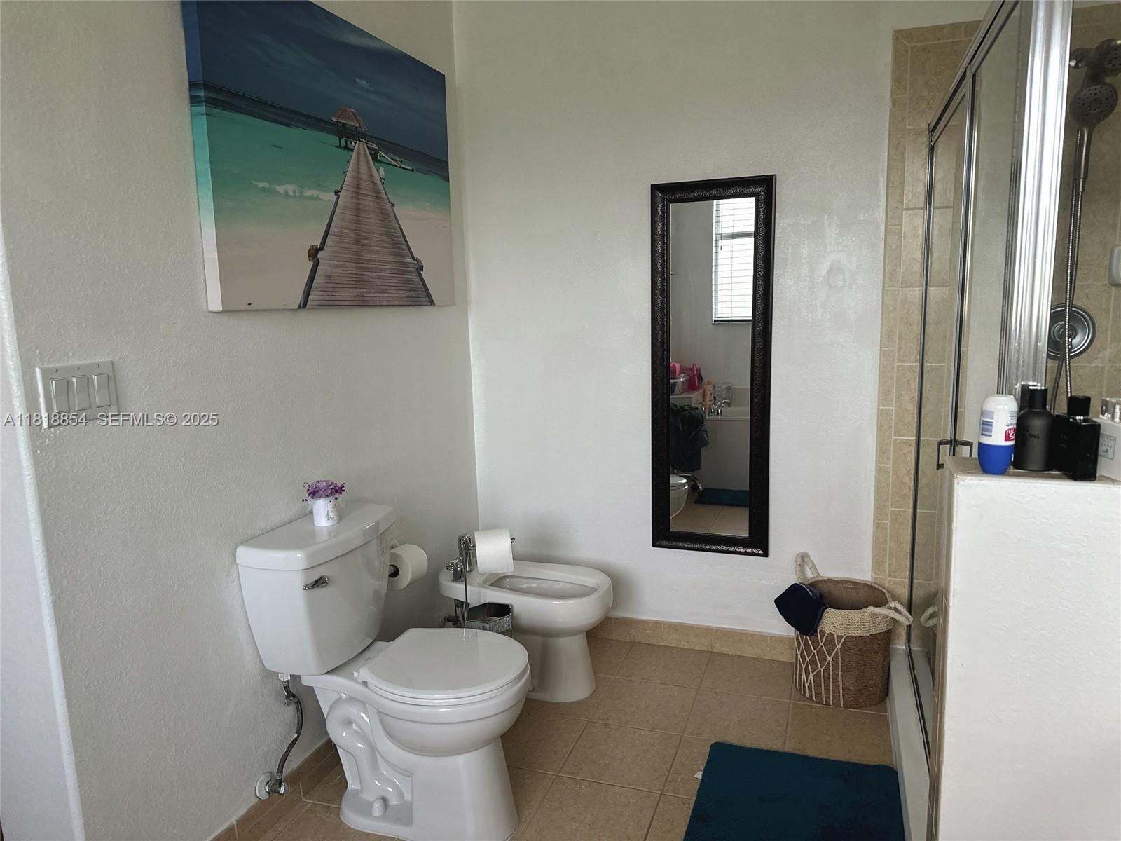 16419 Southwest 84th Street Miami, FL 33193 - Photo 12 of 15 a bathroom with a toilet sink and mirror