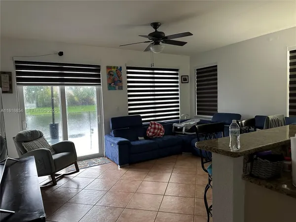 a work room with furniture and a floor to ceiling window