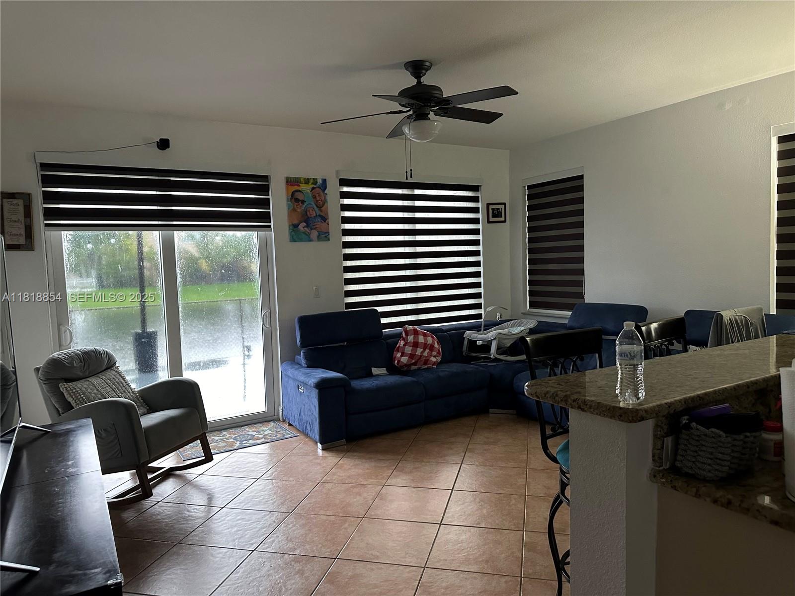 16419 Southwest 84th Street Miami, FL 33193 - Photo 3 of 15 a work room with furniture and a floor to ceiling window