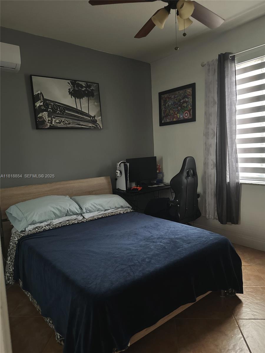 16419 Southwest 84th Street Miami, FL 33193 - Photo 5 of 15 a bedroom with a bed and two windows