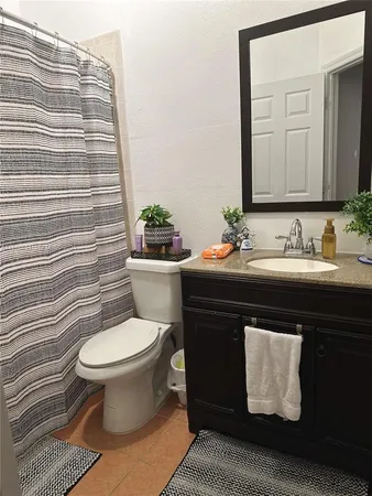 a bathroom with a sink toilet and mirror