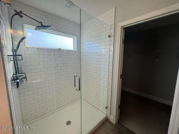 a bathroom with a glass shower door