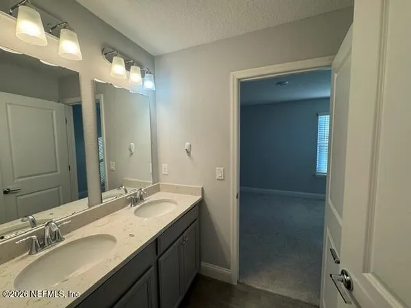a bathroom with a sink vanity and a mirror