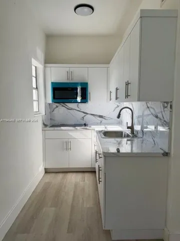 a utility room with sink dryer and washer