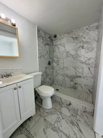 a bathroom with a toilet sink and shower