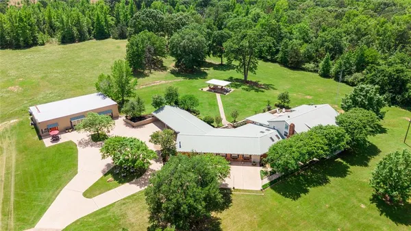 an aerial view of a house with yard
