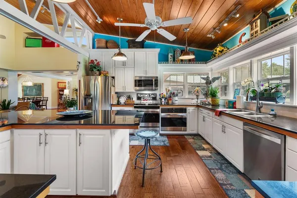a kitchen with stainless steel appliances granite countertop a sink and cabinets