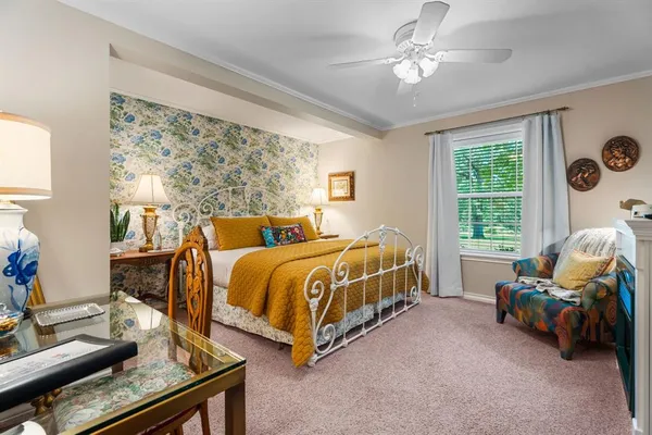 a bed sitting in a bedroom next to a window