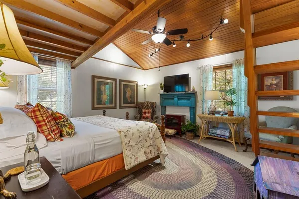 a bedroom with a bed and a fireplace