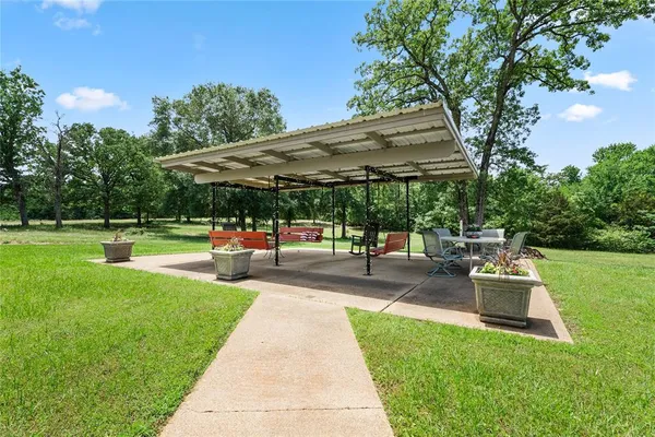 a view of a backyard with sitting area