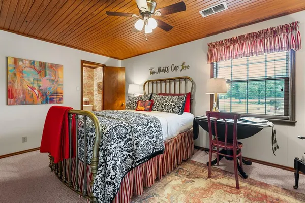 a bedroom with a bed and a large window