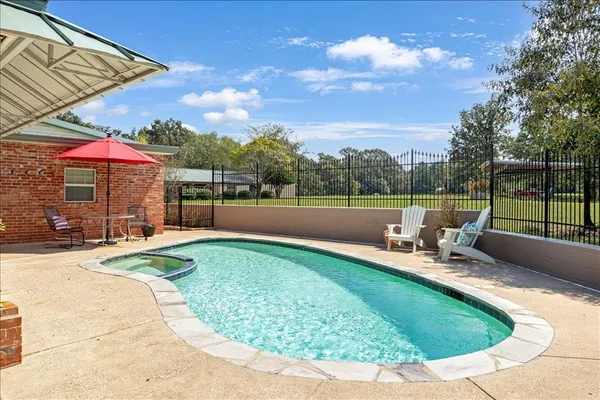 a view of a swimming pool with a patio