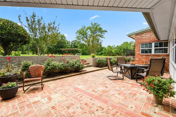 a view of a chairs and tables in the back yard of the house