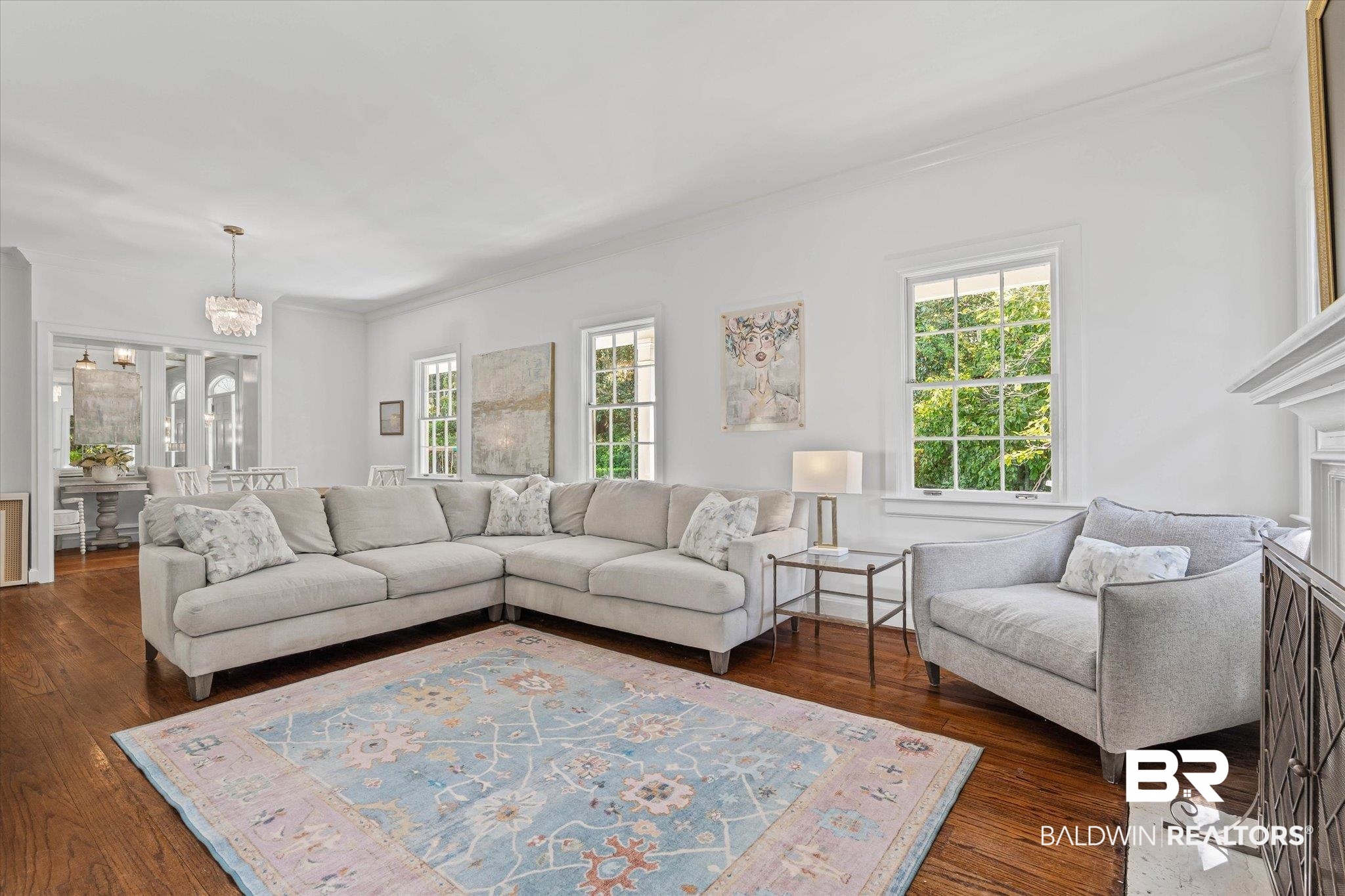 151 Tuthill Lane Mobile, AL 36608 - Photo 8 of 41 Living room with dark wood-style flooring, healthy amount of natural light, crown molding, and a chandelier