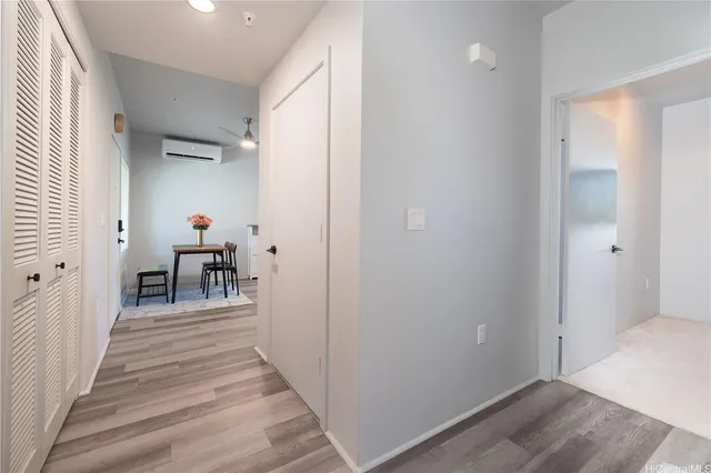 a view of a hallway with a livingroom and furniture
