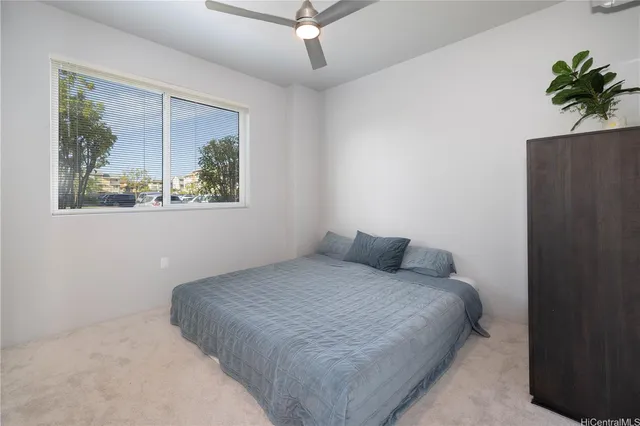 a bedroom with a bed and a painting on the wall