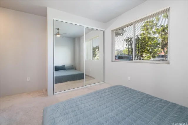 an empty room with windows and closet