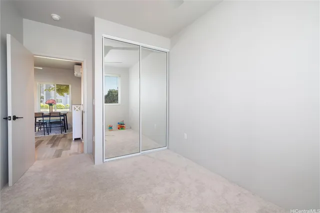 an empty room with mirror and furniture