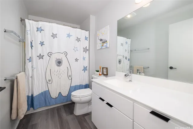 a bathroom with a sink toilet and shower