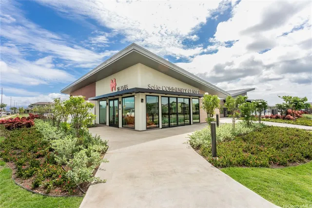 a view of a house with garden and pathway
