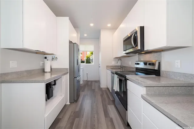 a kitchen with stainless steel appliances granite countertop a sink and a stove top oven