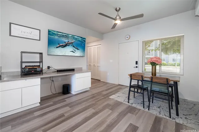 a view of a workspace with furniture and a kitchen